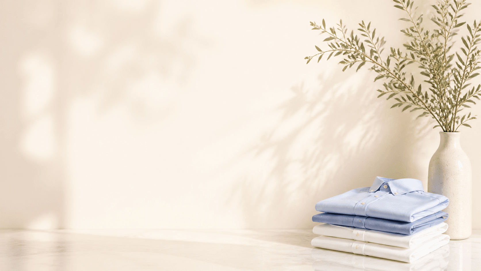 Folded shirts and natural branches in a warm interior